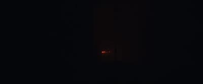 a red light is shining in the dark