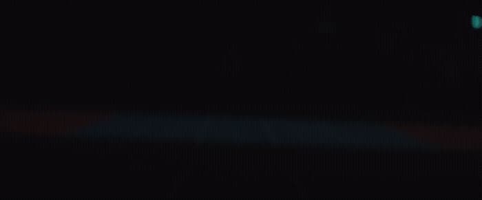 a blurry image of a traffic light in the dark