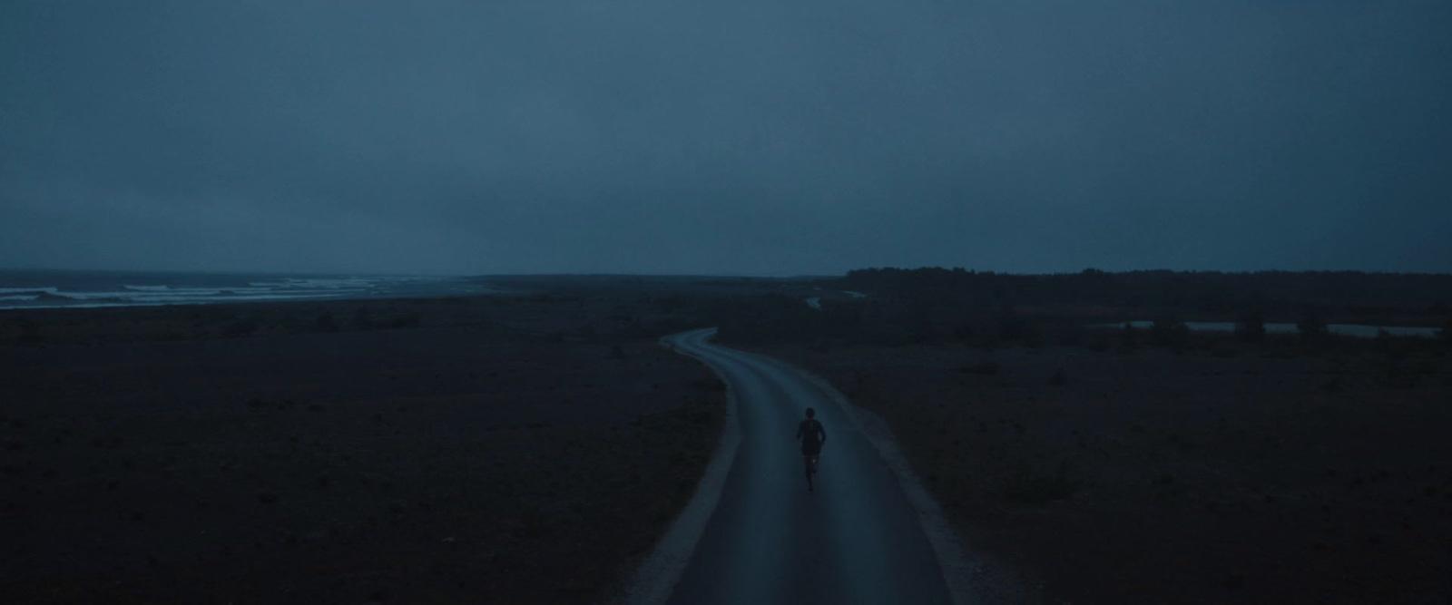 a person walking down a road at night
