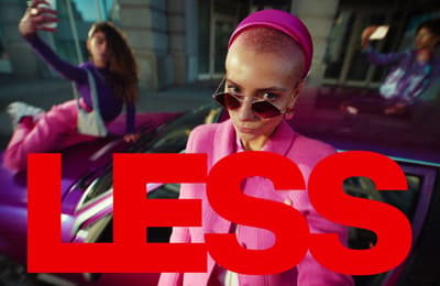 a woman in a pink outfit standing next to a car