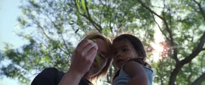 a woman holding a child up in the air