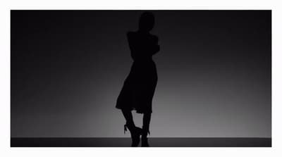 a silhouette of a woman in a dress