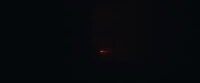 a red light is shining in the dark