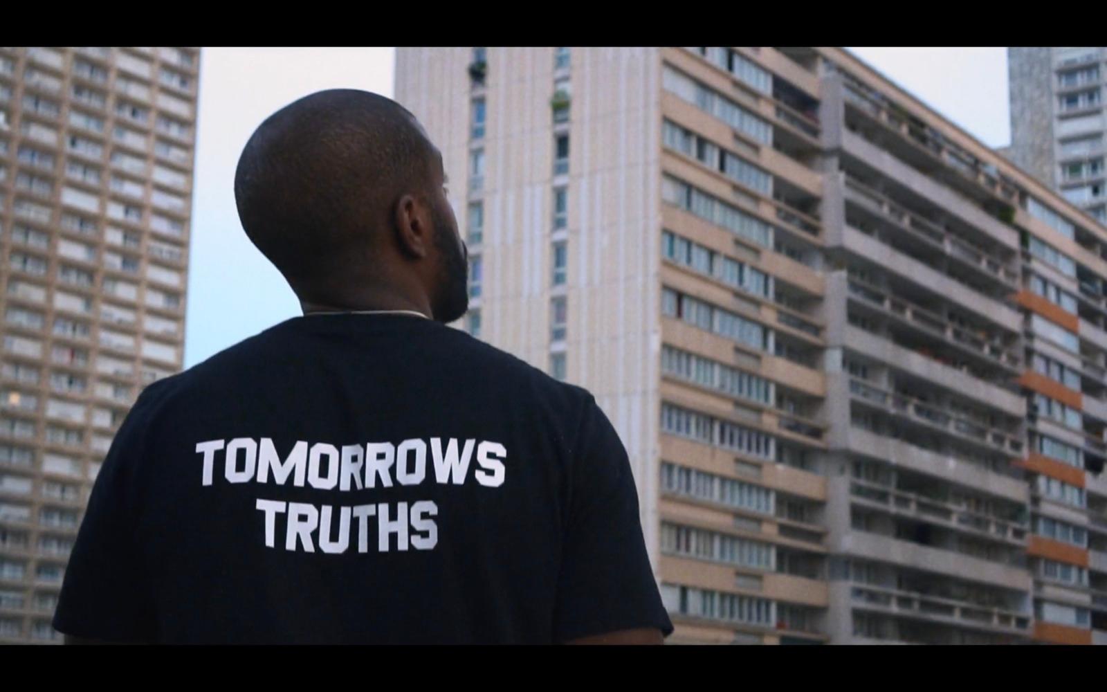 a man standing in front of tall buildings