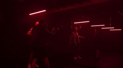 a group of people standing in a dark room
