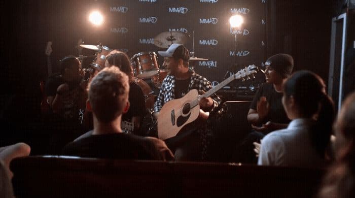 a group of people playing instruments in a room