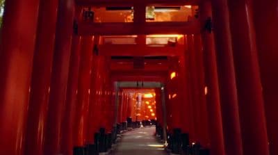 a long hallway lined with red columns and lights