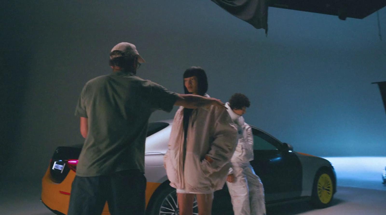 a group of people standing around a car