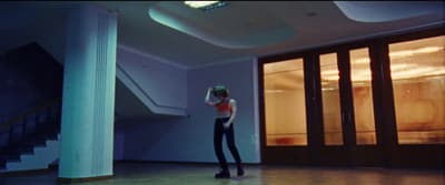 a person standing in a room with a mop