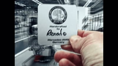 a person is holding up a business card