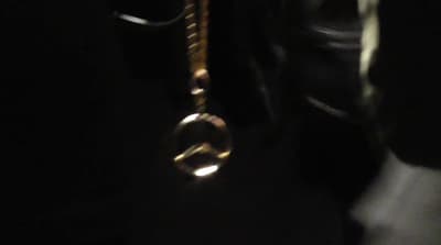 a close up of a tie hanging from a hook