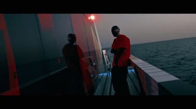 a couple of people standing on top of a boat