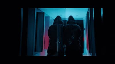 a couple of people standing in front of a mirror