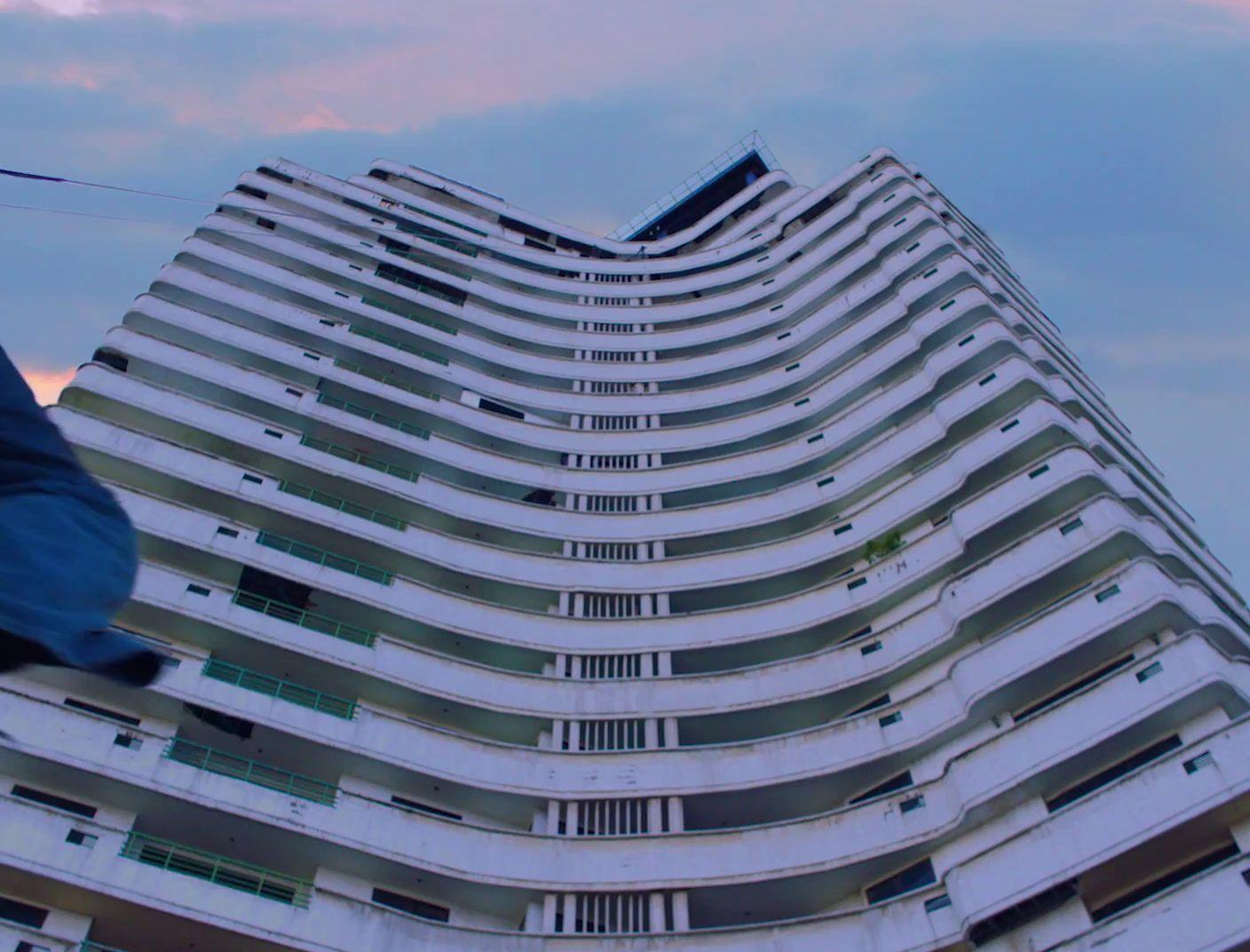 a tall white building with lots of windows