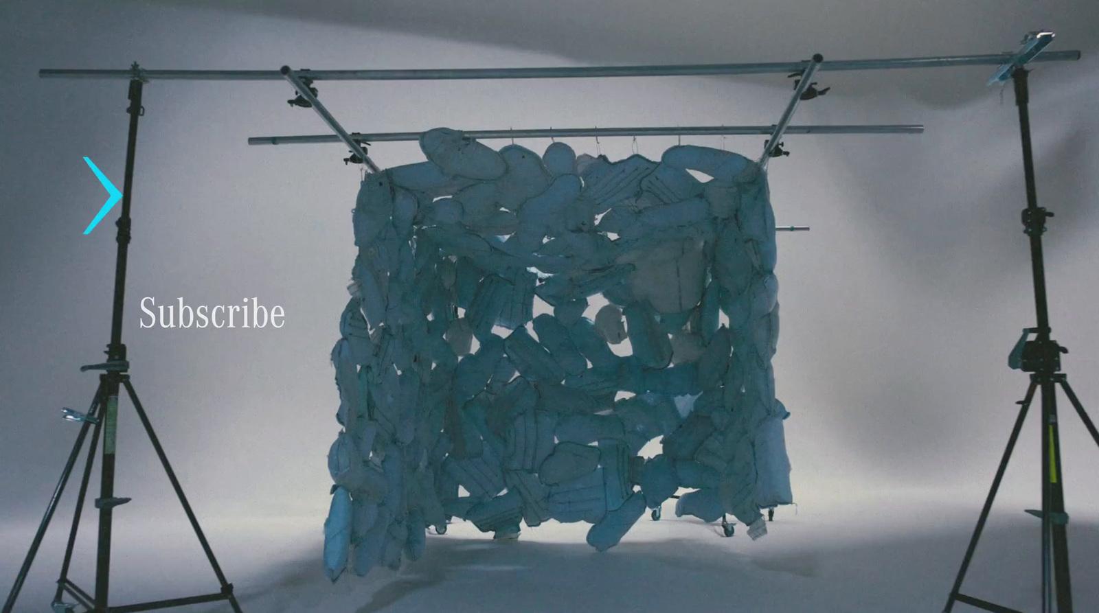 a picture of a blue piece of cloth hanging on a tripod