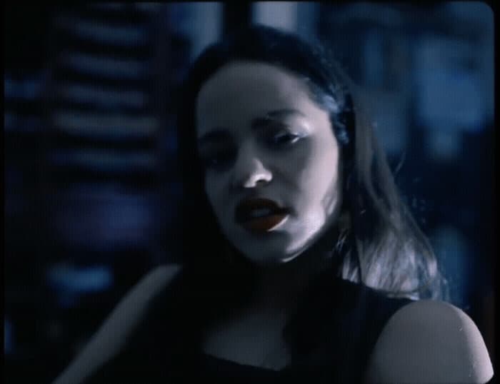 a woman in a black dress with her mouth open