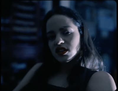 a woman in a black dress with her mouth open