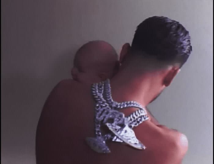 a man holding a baby in his arms
