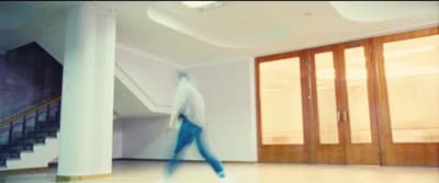 a blurry photo of a person walking in a room