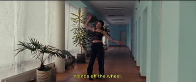 a woman standing in a hallway with her arms outstretched