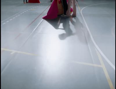 a woman in a pink dress is walking down the street