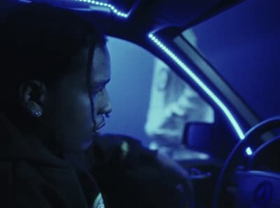 a woman driving a car in the dark