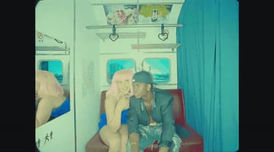 a man and a woman sitting on a train