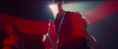 a blurry photo of a man in a red shirt