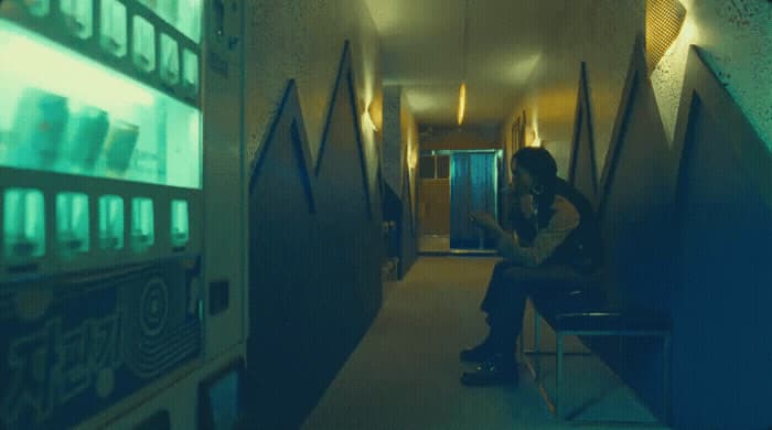 a person sitting on a bench in a hallway