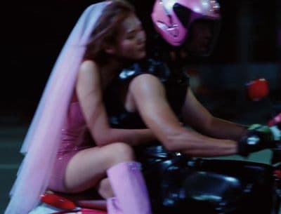 a man and a woman riding a motorcycle together