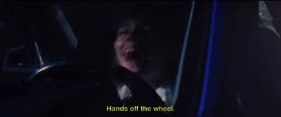 a man driving a car with his mouth open