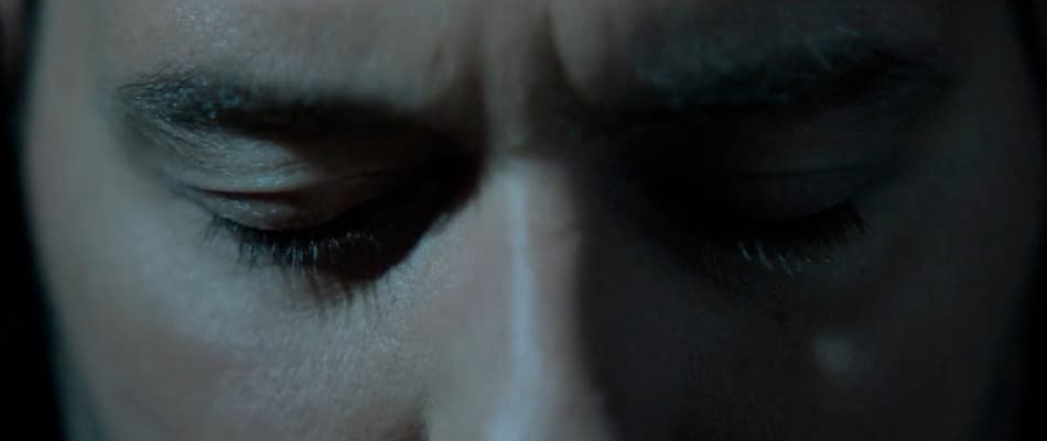 a close up of a person with their eyes closed