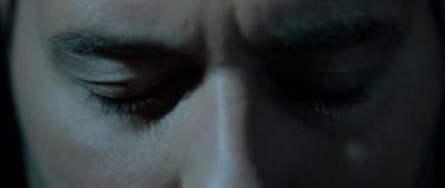 a close up of a person with their eyes closed