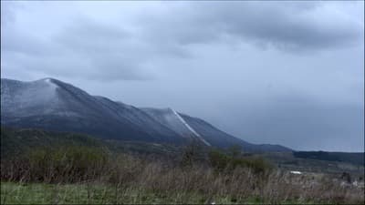 a snow covered mountain range in the distance