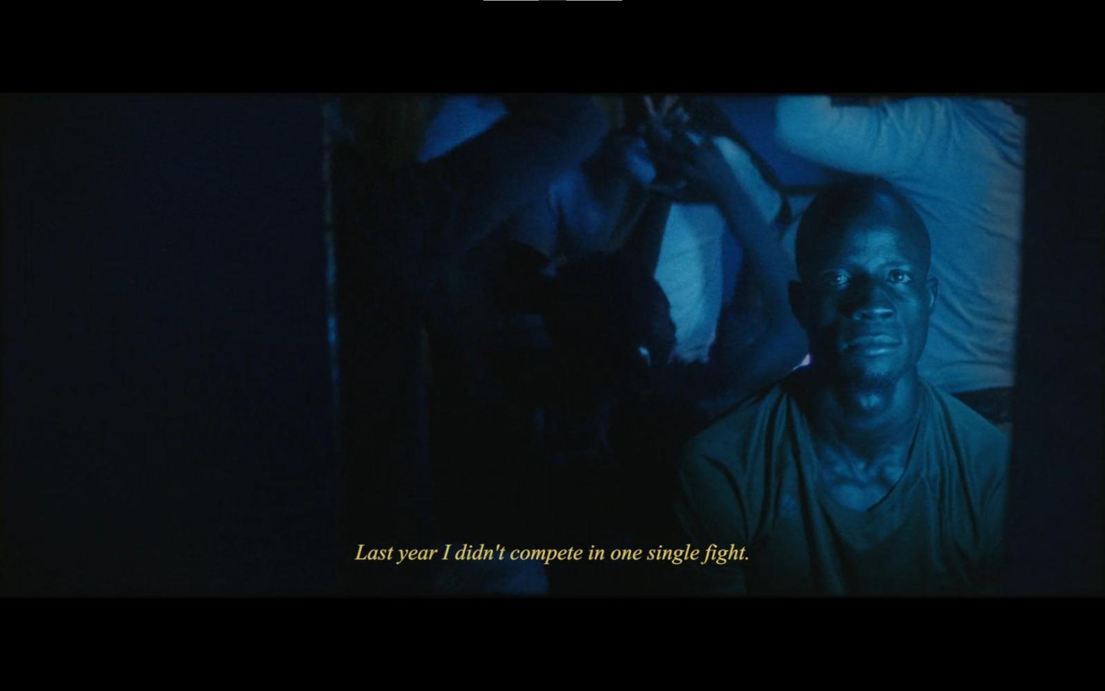 a man in a dark room with a quote on it