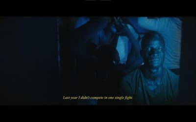 a man in a dark room with a quote on it
