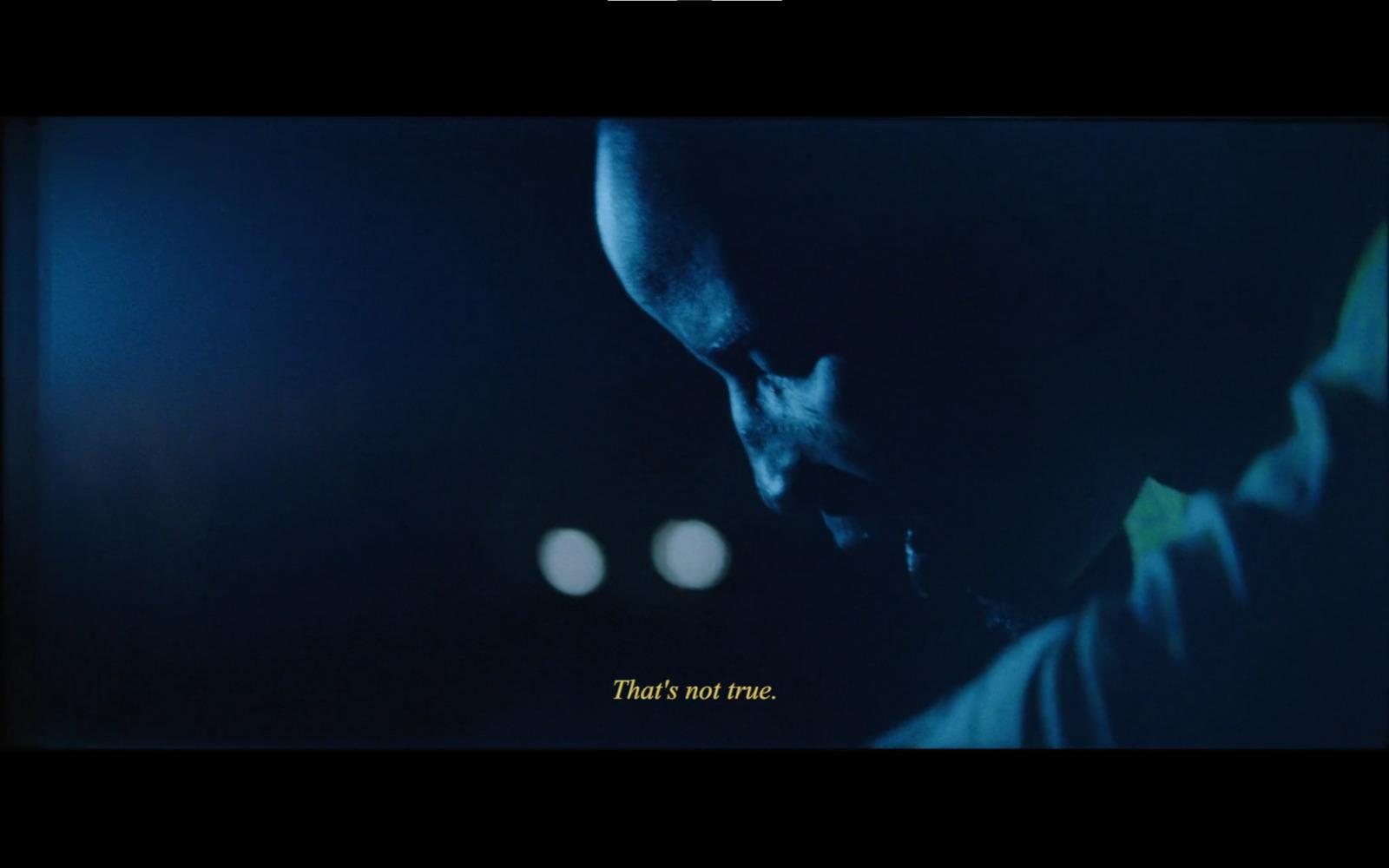 a picture of a man looking down at his cell phone