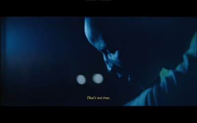 a picture of a man looking down at his cell phone
