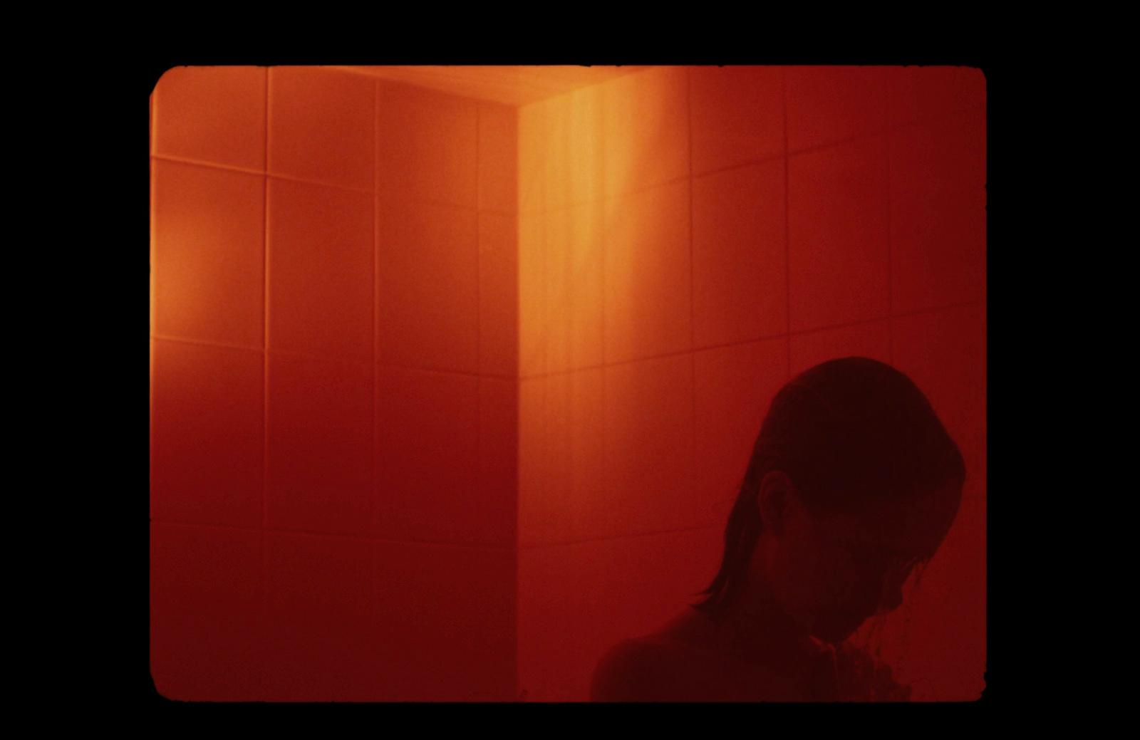 a woman standing in front of a red light