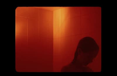 a woman standing in front of a red light