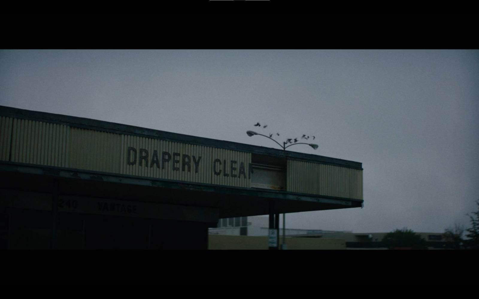 a sign on top of a building that says draper clear