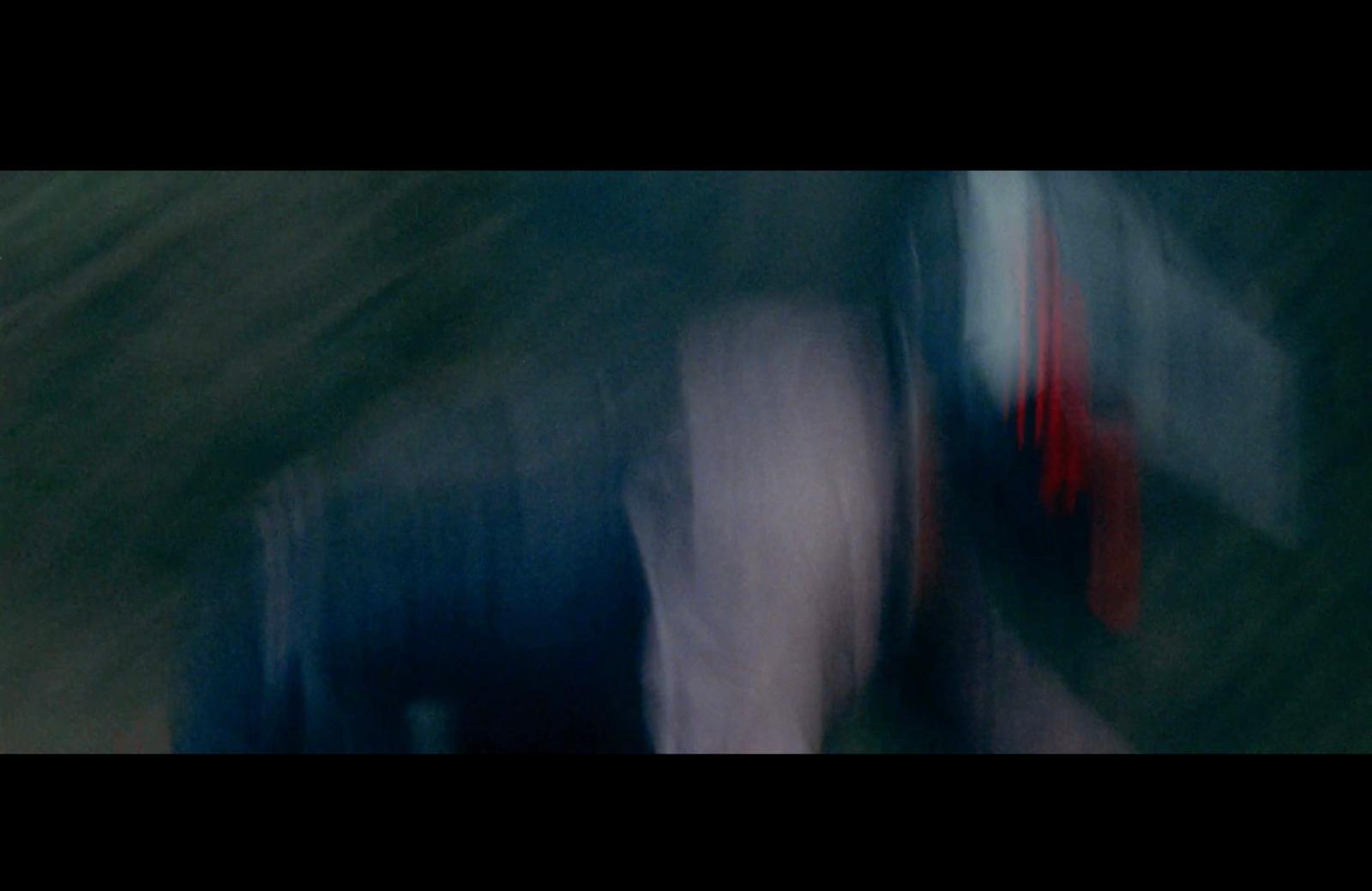 a blurry photo of a person walking down a street