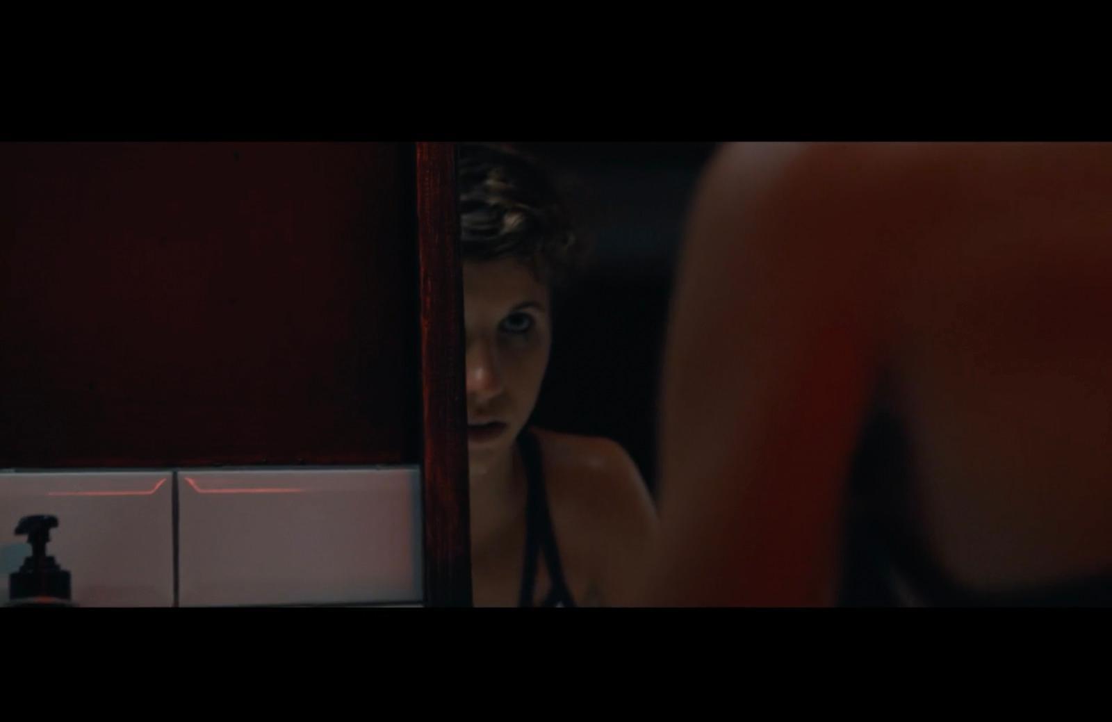 a woman looking at herself in the mirror