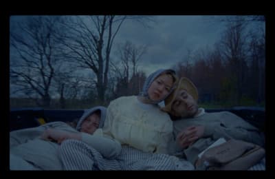 a couple of people laying in a bed together