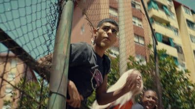 a man holding a frisbee in front of a net