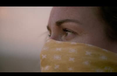 a close up of a person wearing a bandana