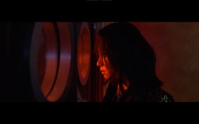 a woman standing in front of a wine rack