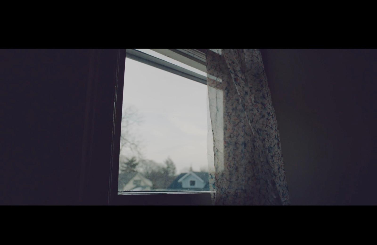a window with a tree outside of it