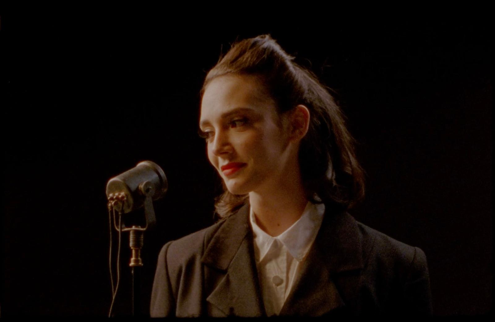 a woman standing in front of a microphone