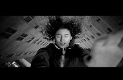 a woman with her hair blowing in the wind